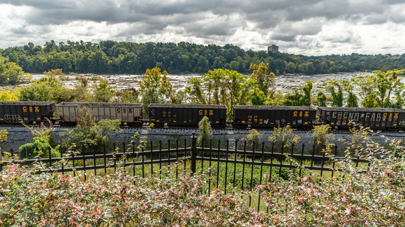 Train cars at rest along the James River